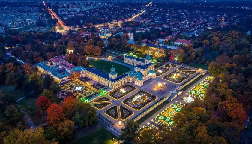 Nocne ogrody świateł Warszawa w Wilanowie. Pałac i iluminowane ogrody w jesiennej scenerii.